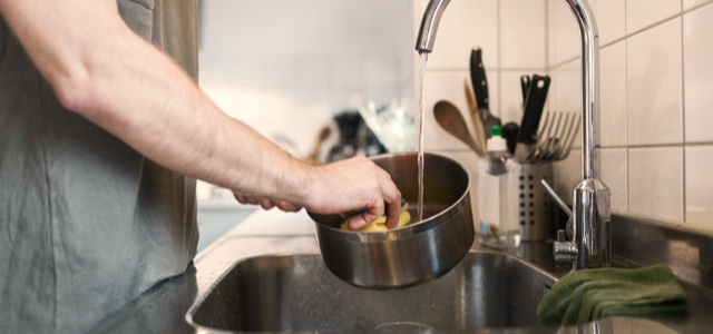 Symptoms of Huntington's disease chorea can complicate everyday tasks, like washing dishes.