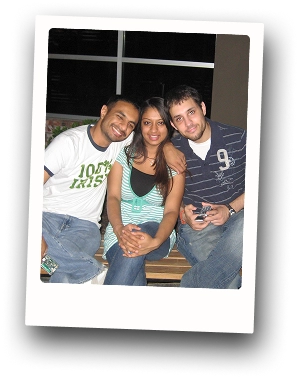 Hiren posing for a picture on the couch with his brother and sister.